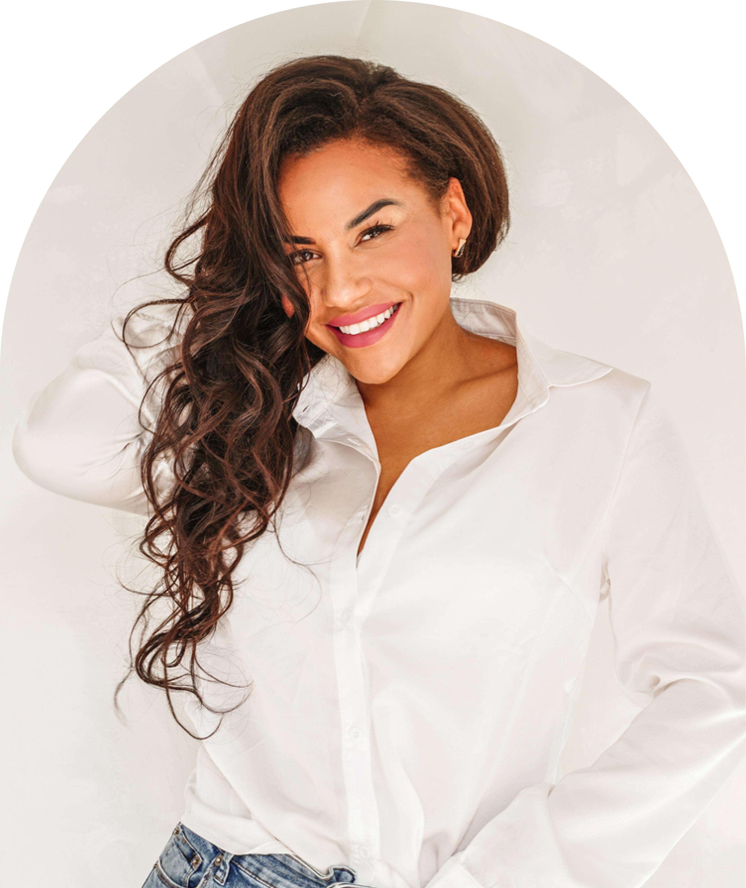 Smiling woman in a white shirt representing women's health and hormonal wellness care