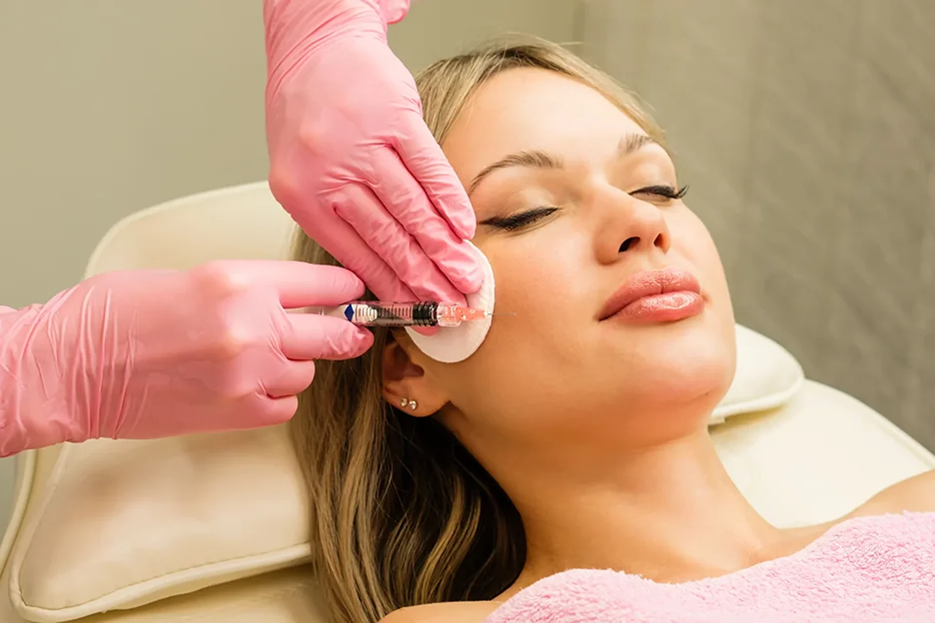a woman getting cheek filler treatment||
