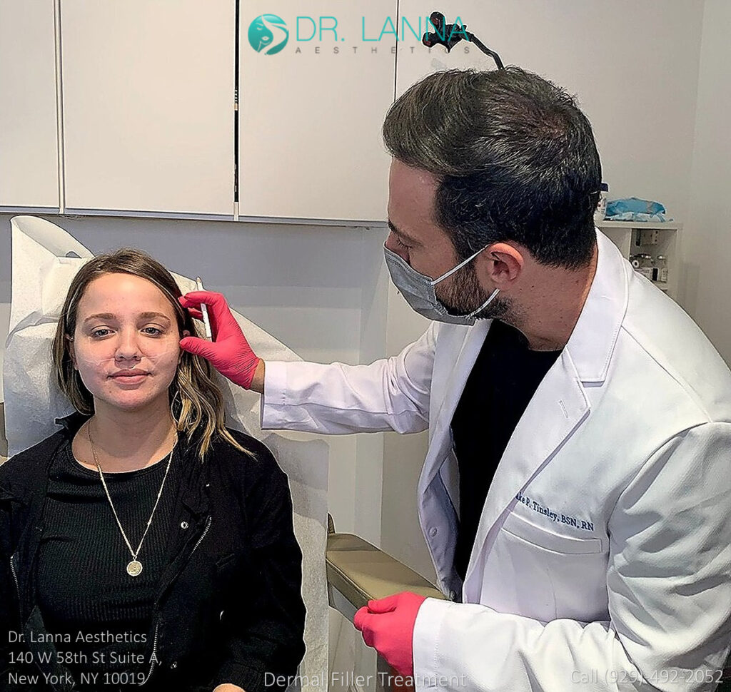 woman receives cheek filler injections inside a beauty clinic