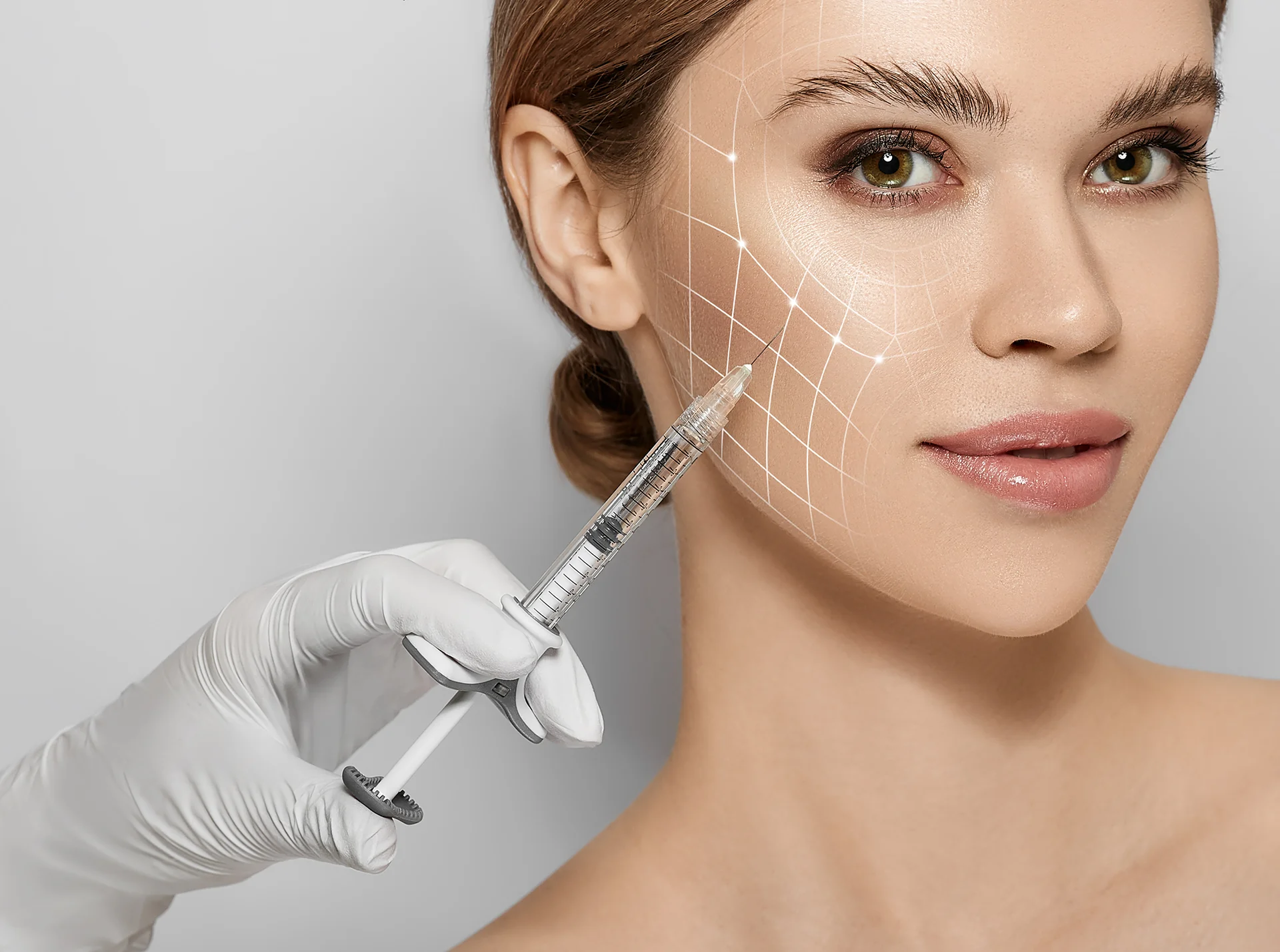 woman receives cheek filler injections|woman receives cheek filler injections inside a beauty clinic