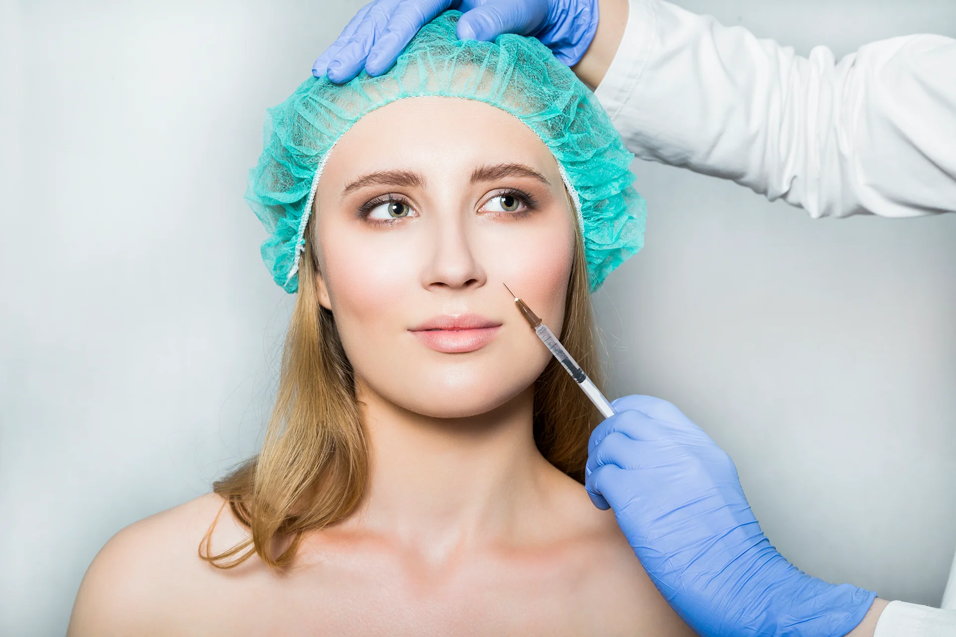 a woman getting cheek filler treatment||||