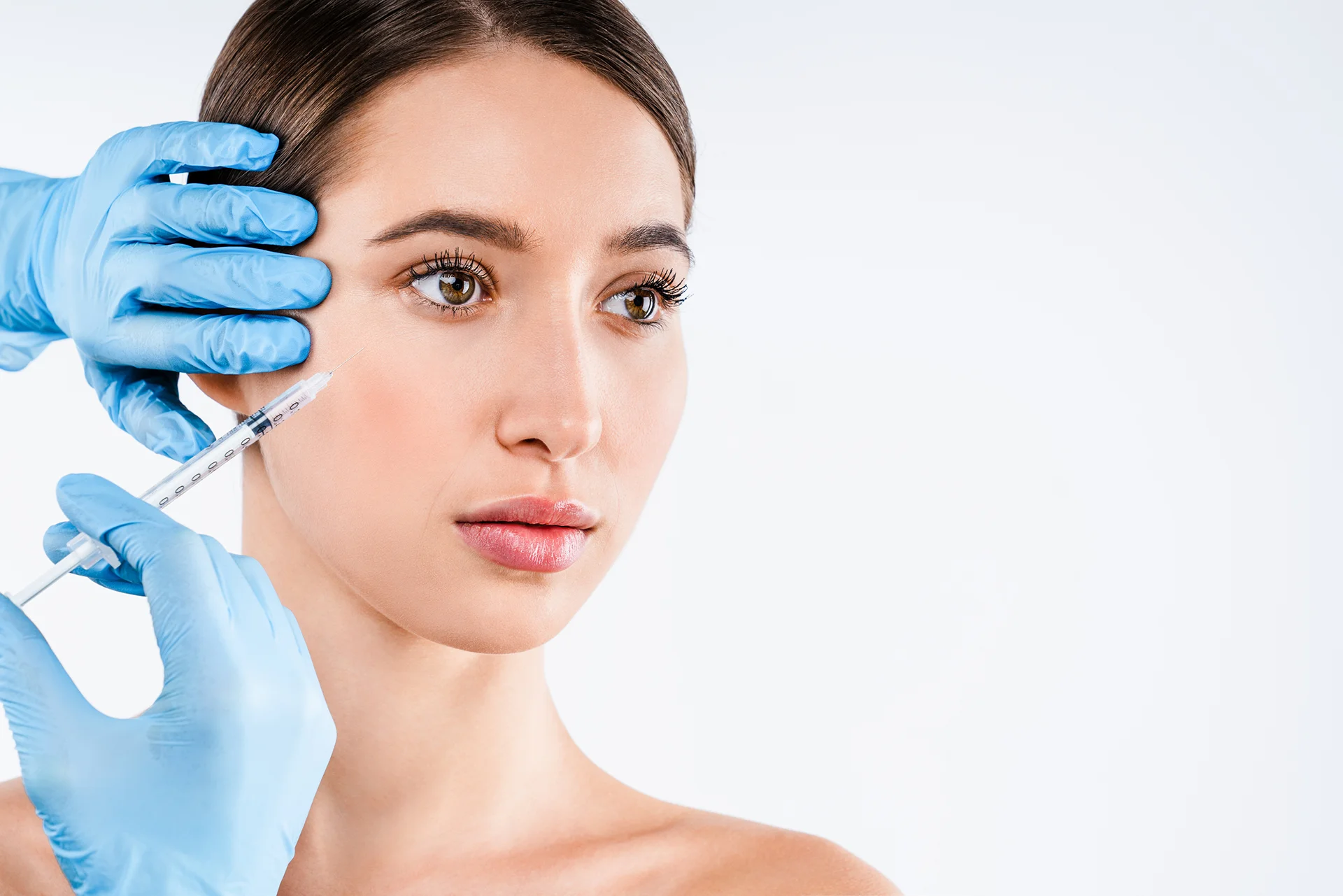 a woman getting cheek filler treatment||||