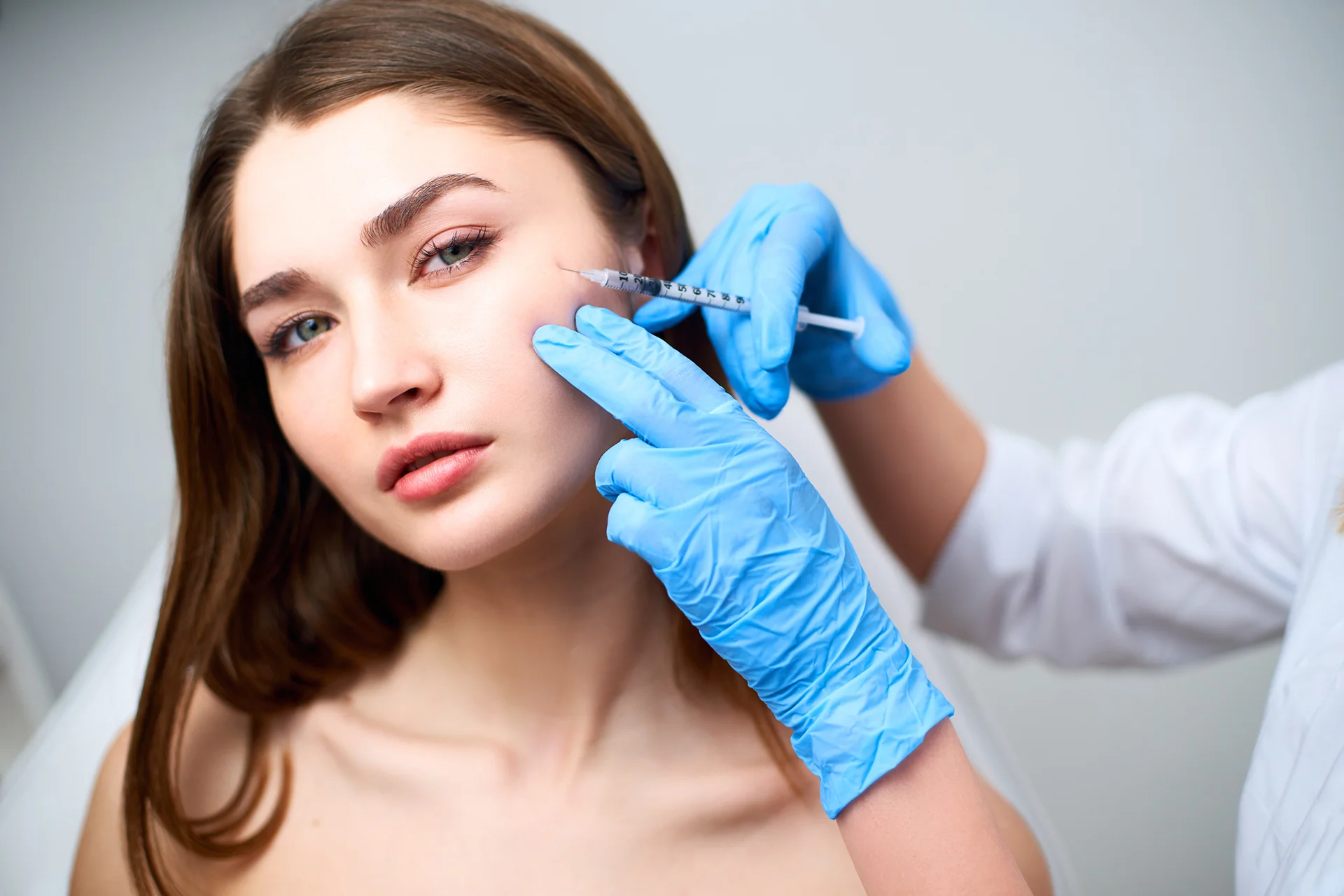 A Woman Getting Cheek Filler Treatment||