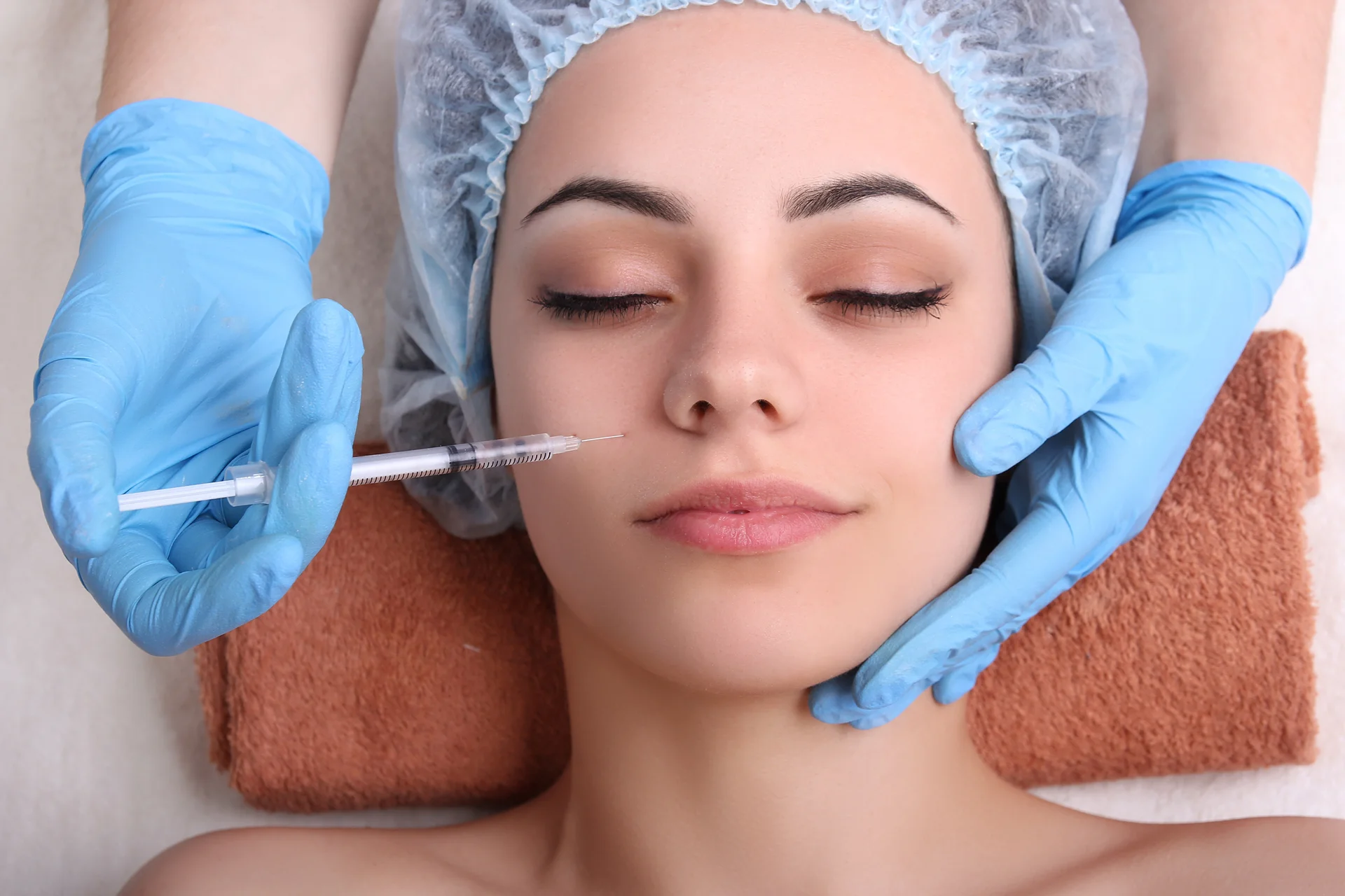 A woman getting cheek filler treatment|||||