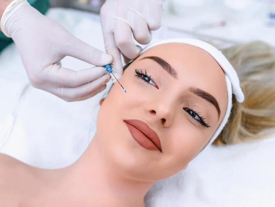 a woman receiving cheek fillers