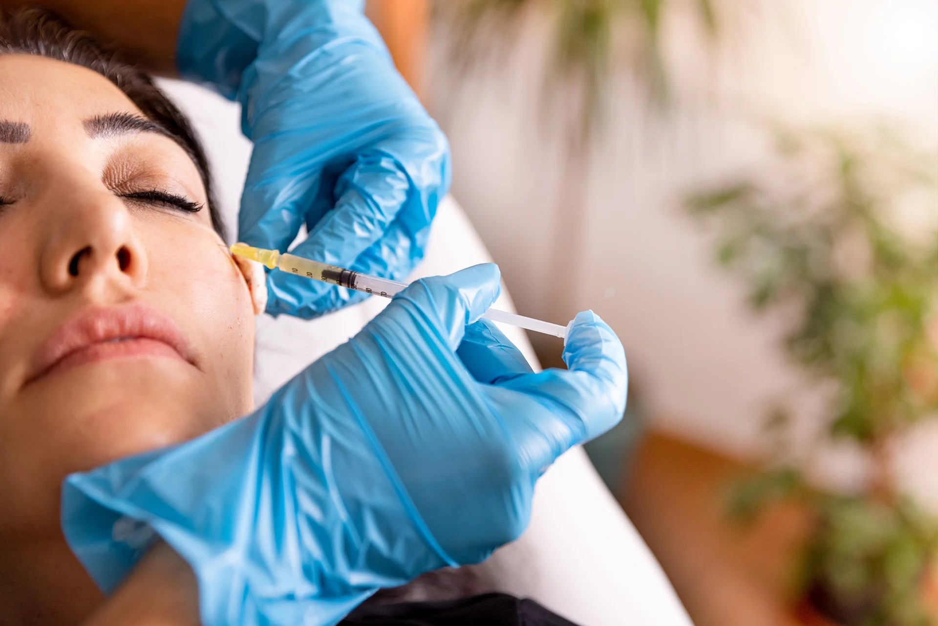 a woman getting cheek filler treatment||