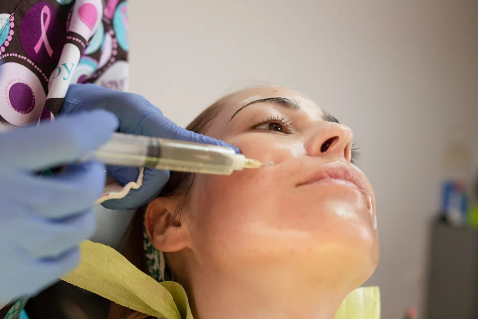 A woman getting cheek filler