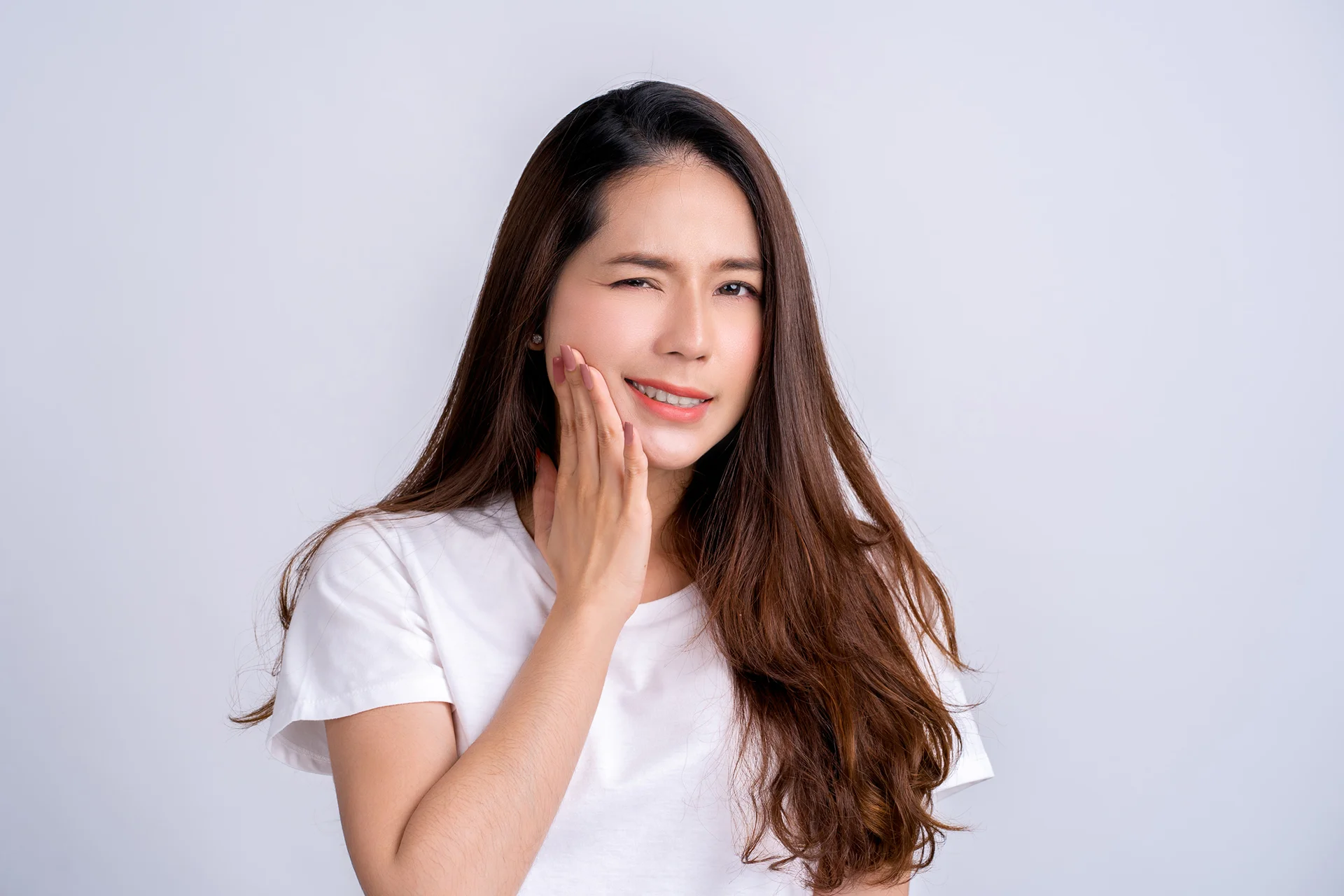 a woman in pain after cheek filler treatment||