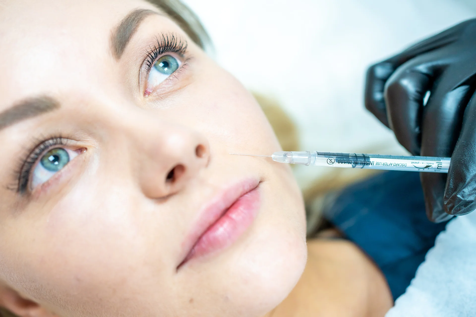 a woman getting cheek fillers||