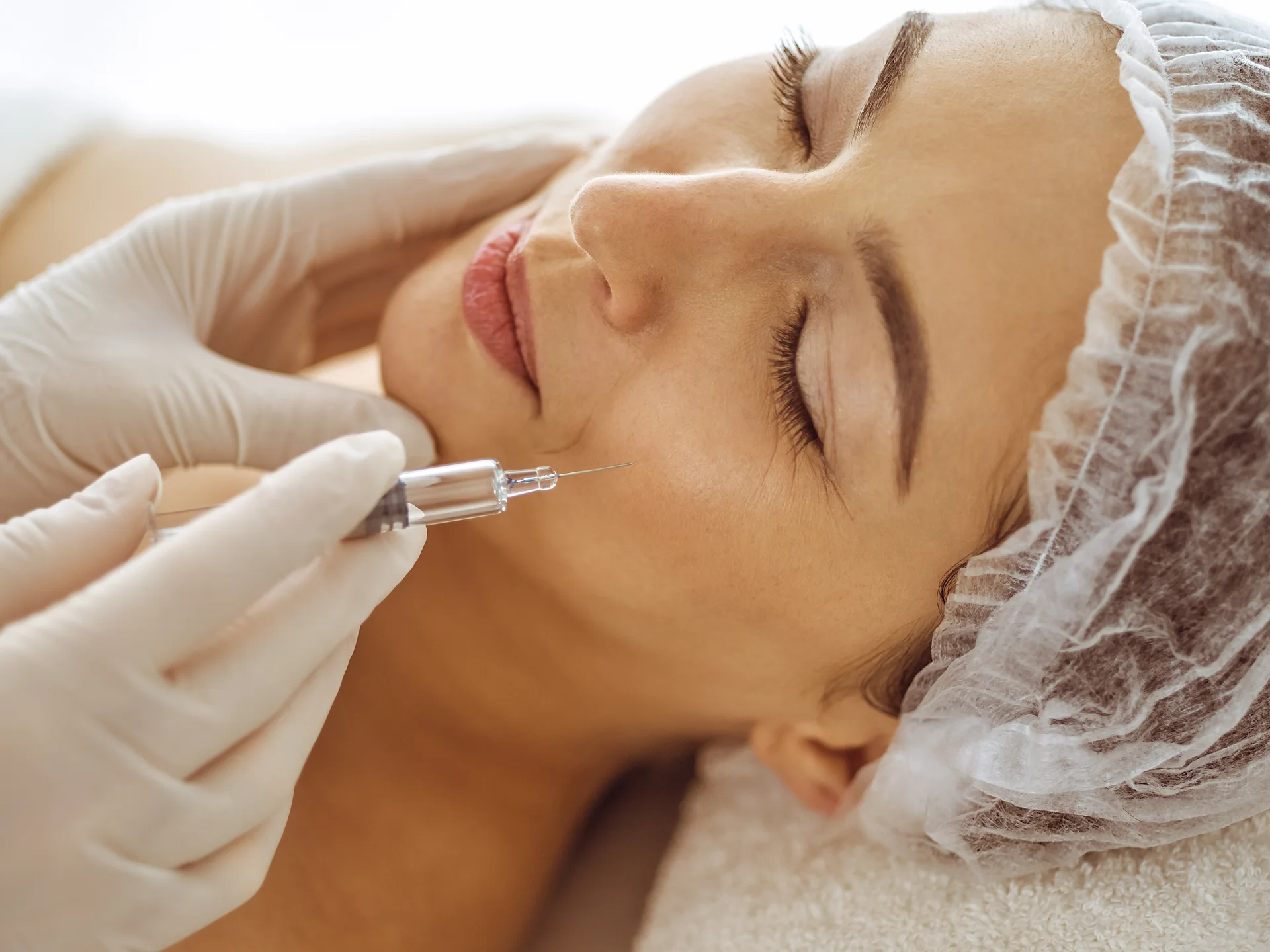 a woman getting cheek filler treatment||