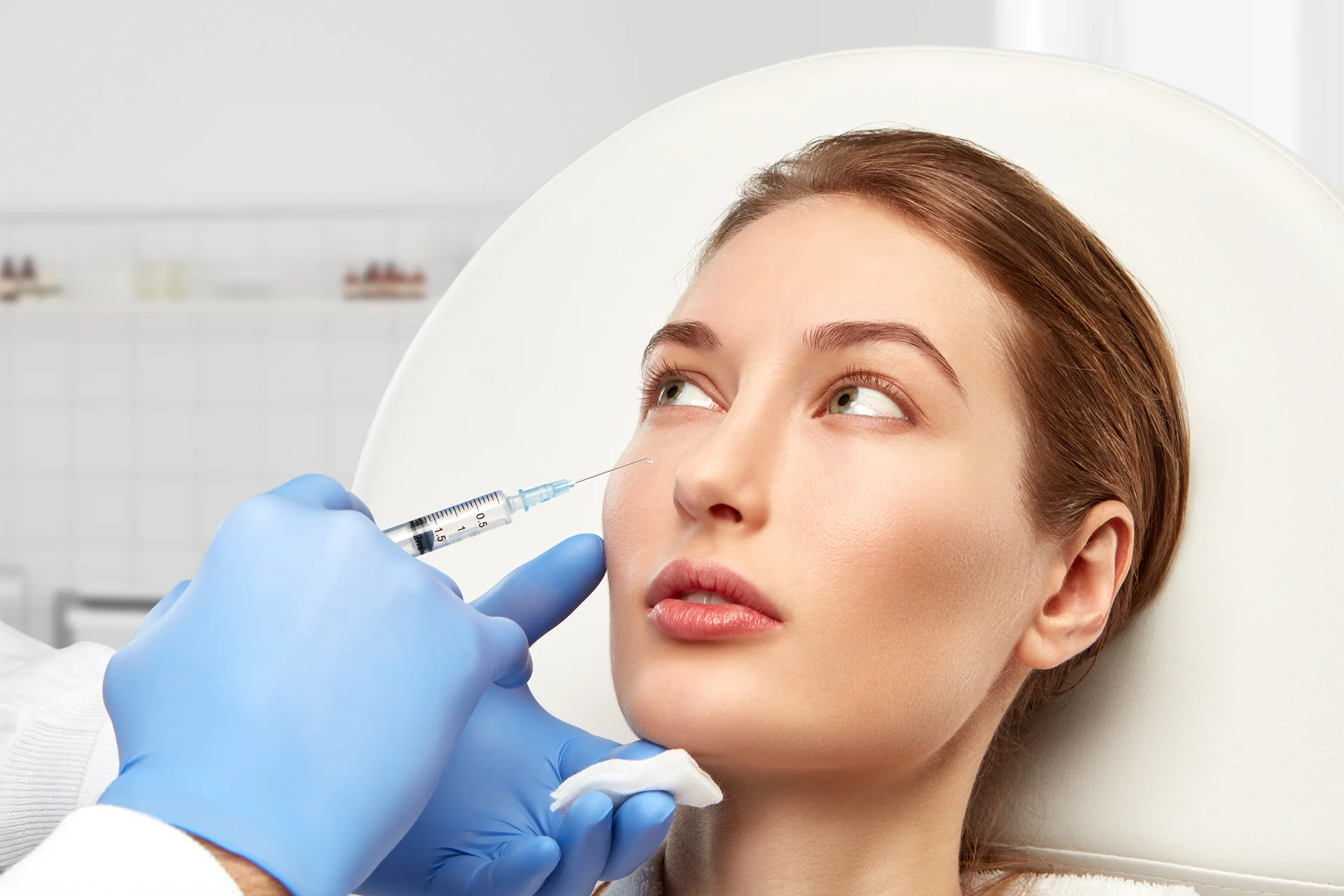 a woman getting cheek filler treatment||||