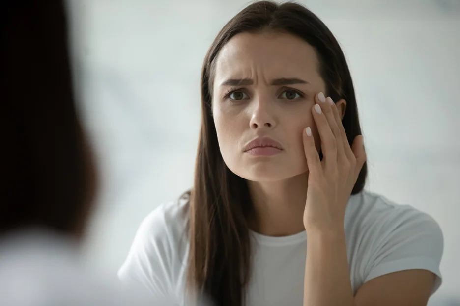 a woman checked her swelling cheeks
