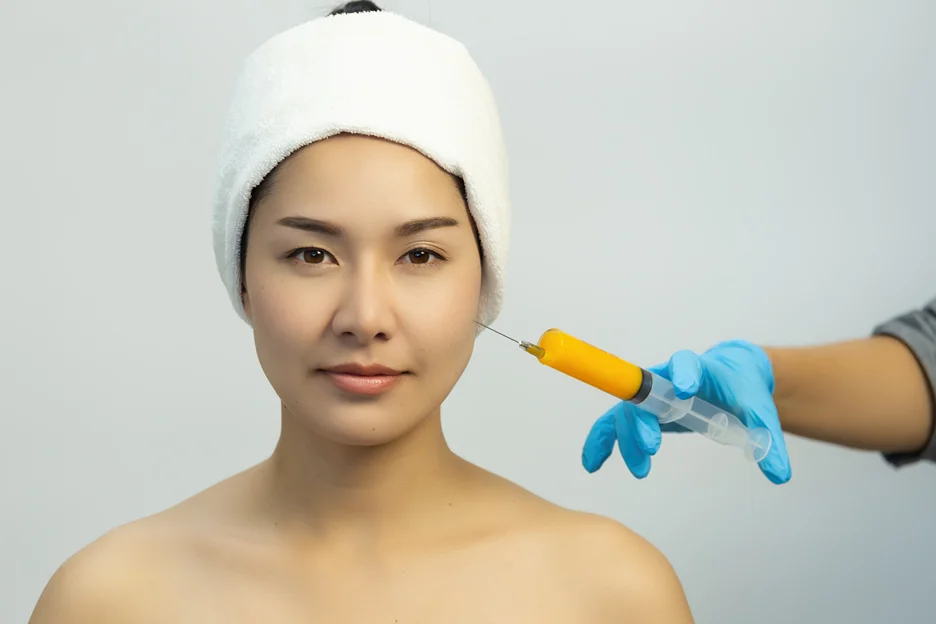 Woman receiving a cheek lift filler injection