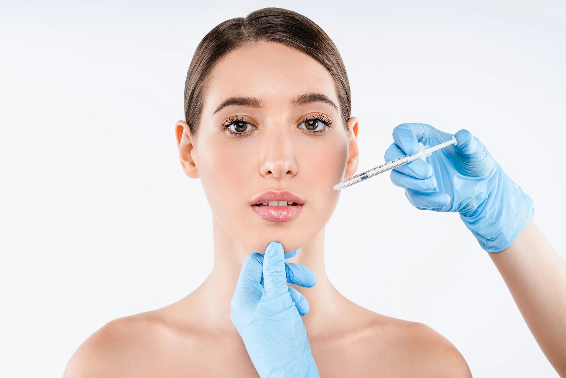 A woman getting filler for her cheek||