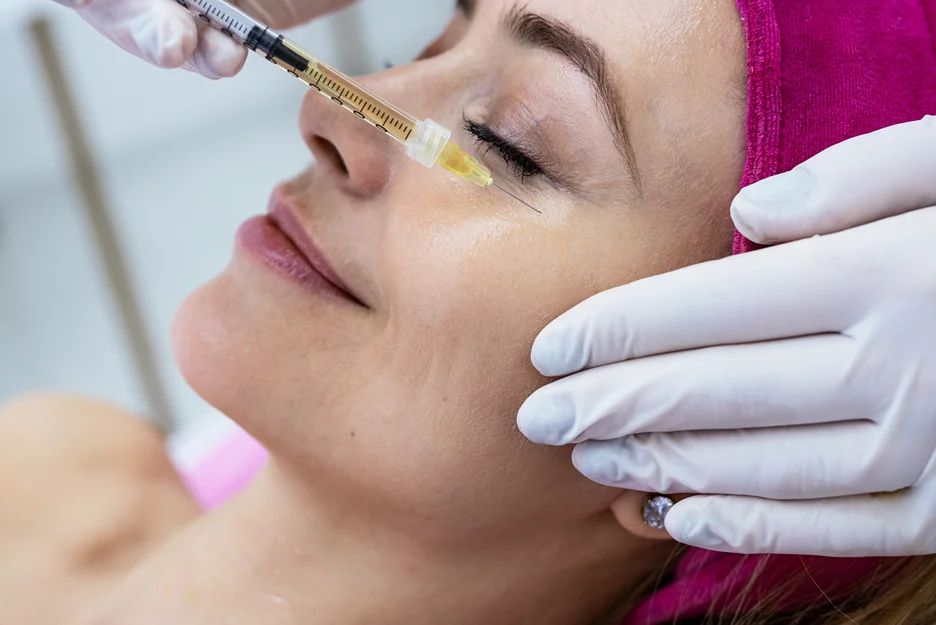 a woman receiving cheek fillers
