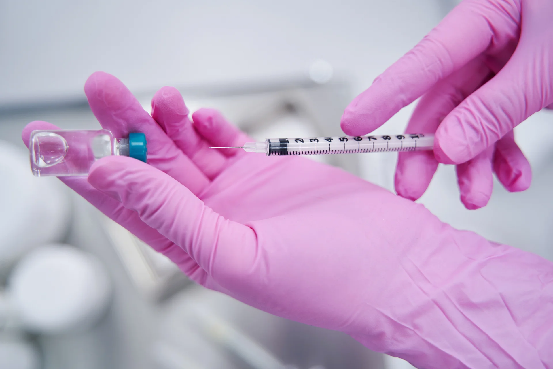syringe and a vial of filler|Dr. Lanna holding syringe with filler