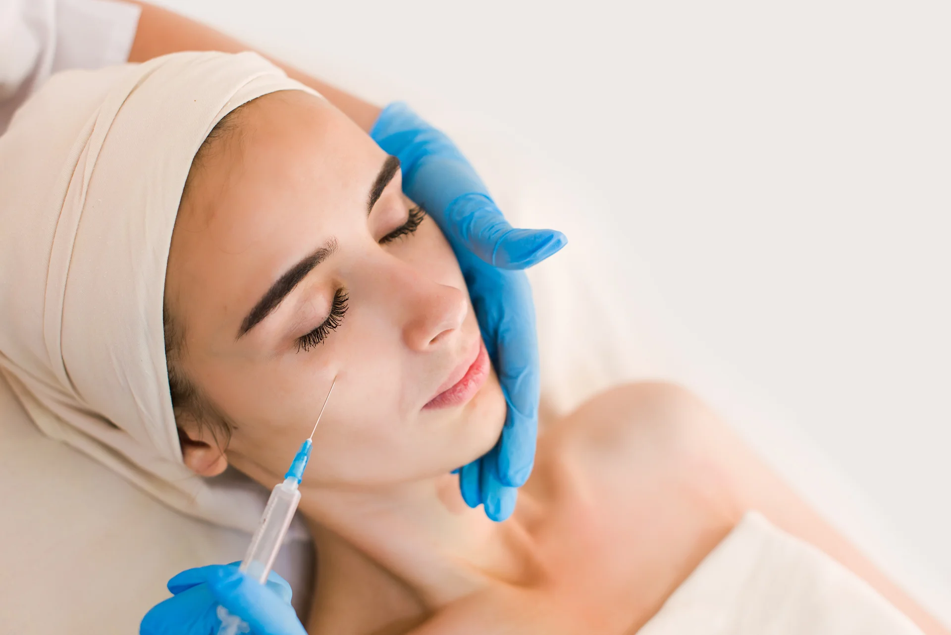 A woman getting cheek filler treatment|||