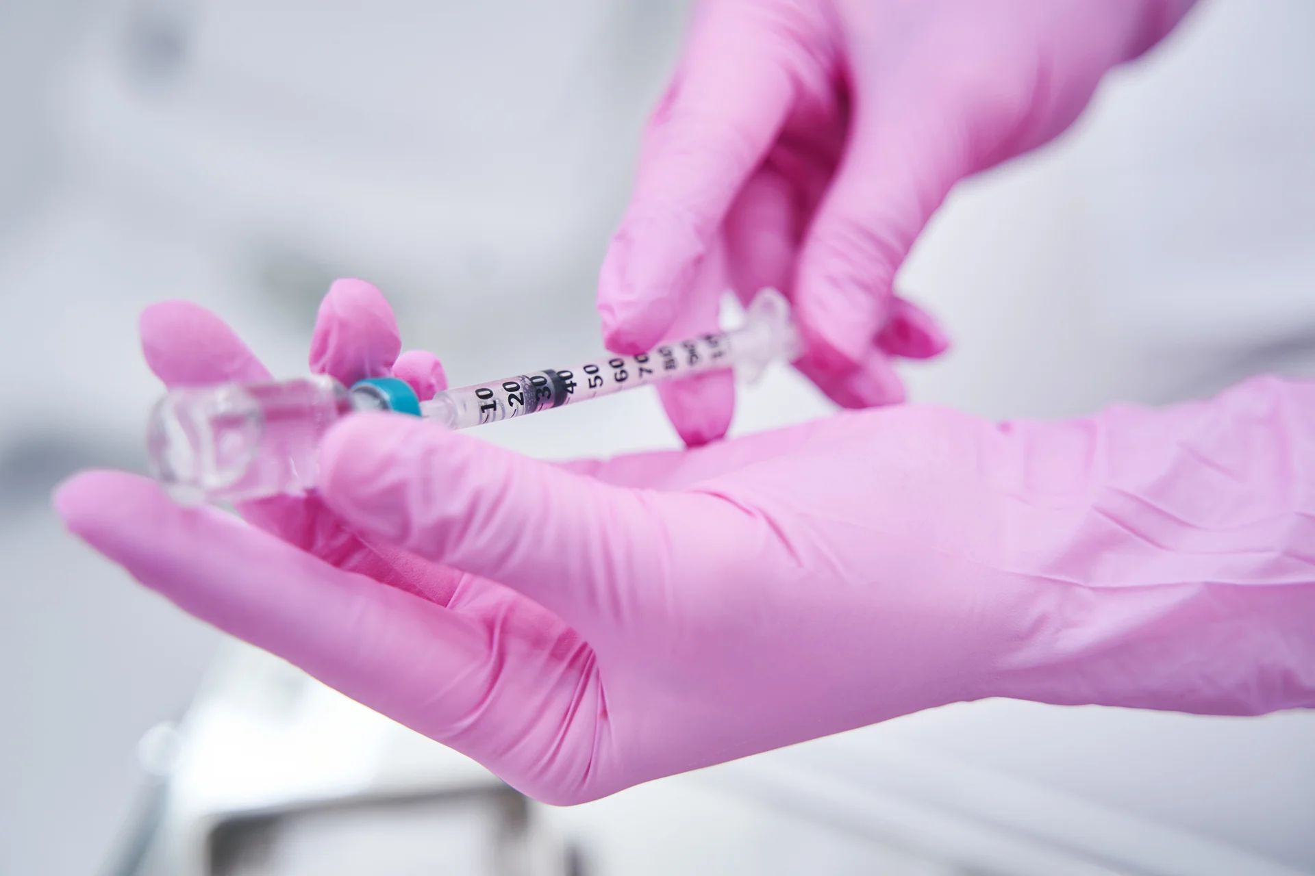 dermal filler in a vial and syringe|a woman receives dermal filler injection|a woman undergoes dermal filler treatment on the chin area