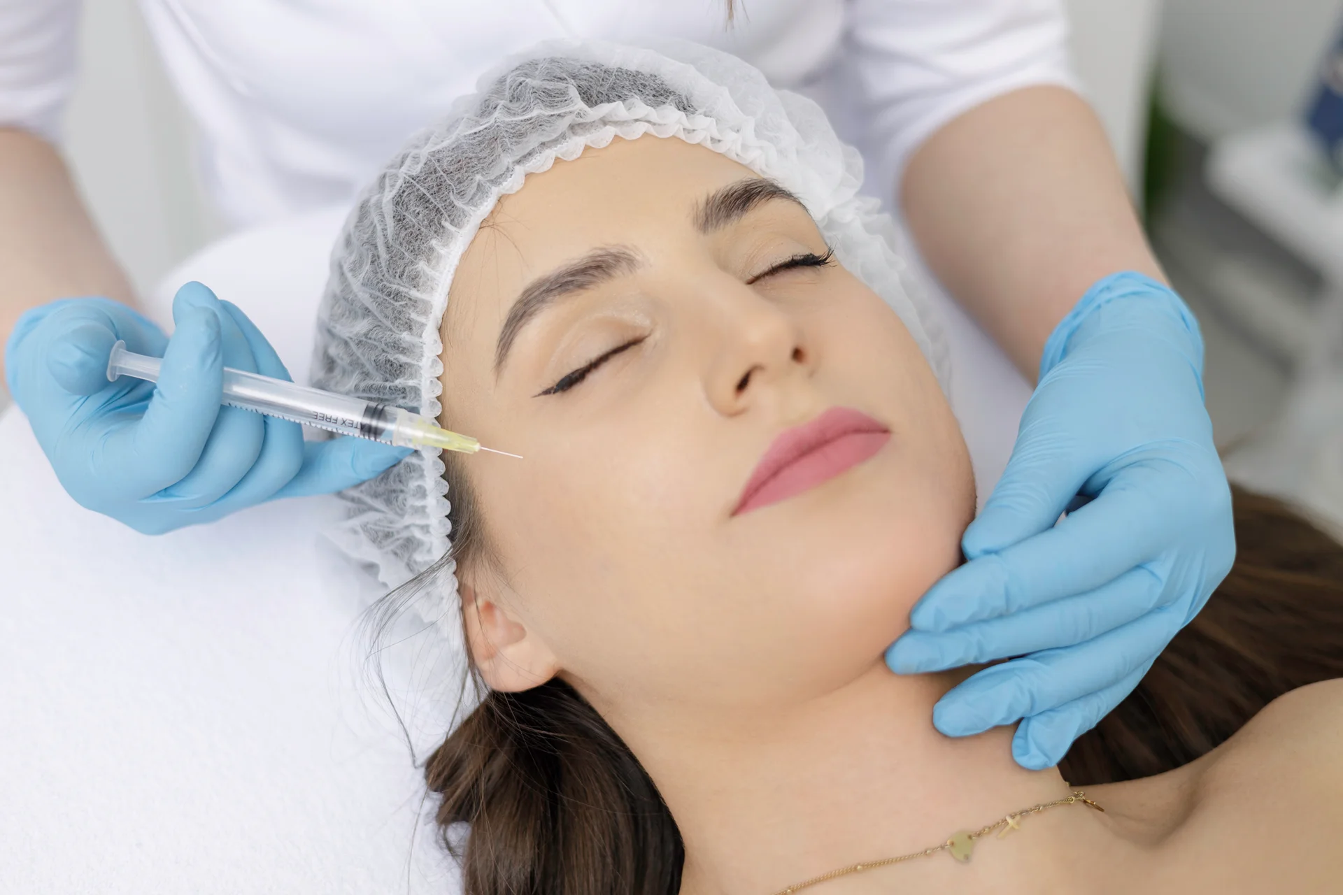 A woman getting cheek filler injection|||