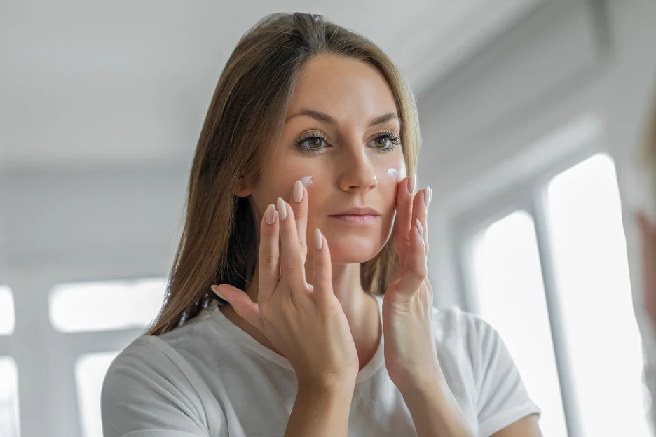 a woman applied moisturizer on her face