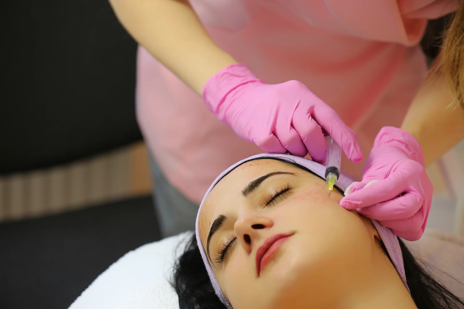 a woman getting cheek filler||