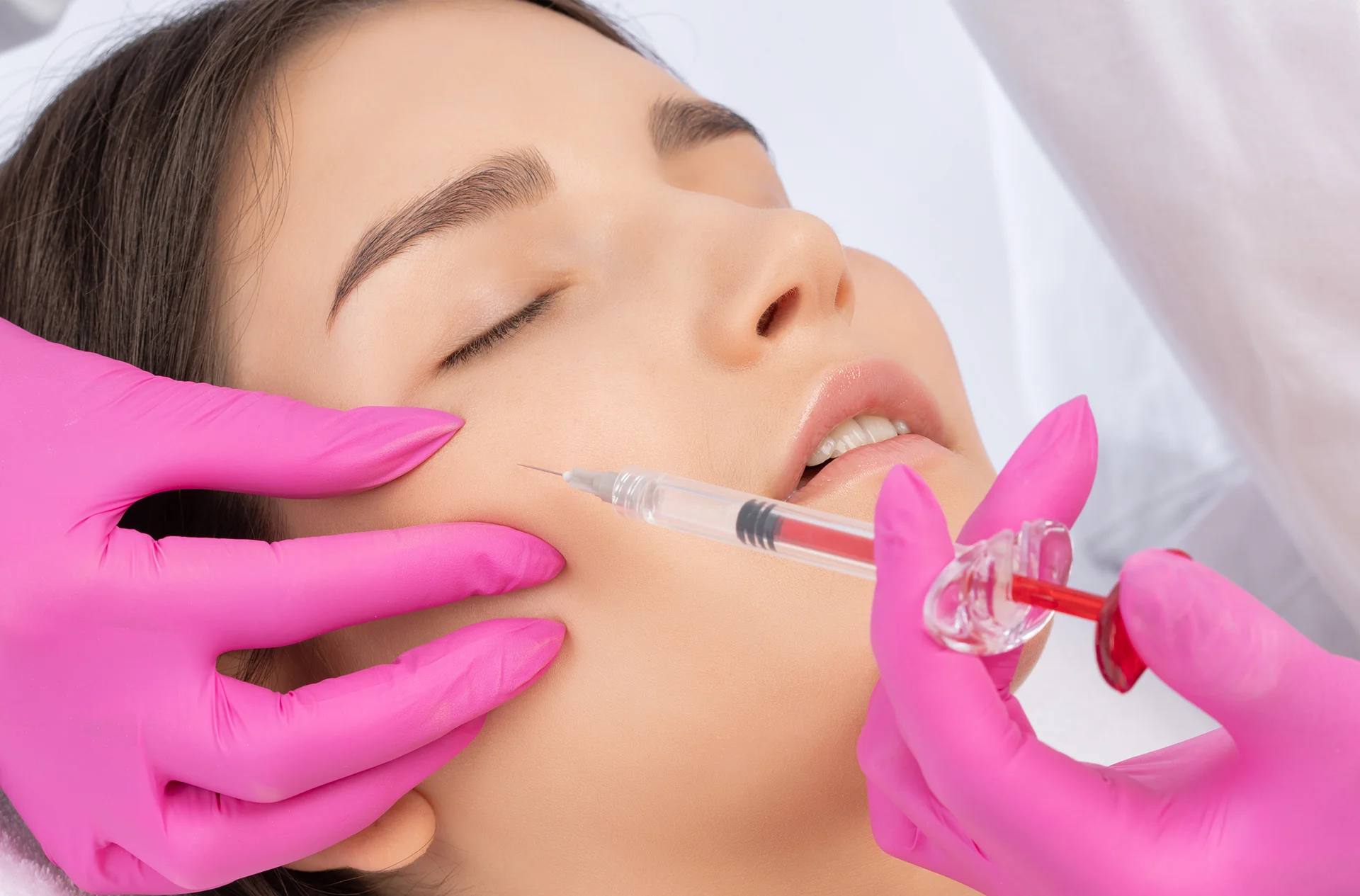 a woman getting cheek filler treatment||