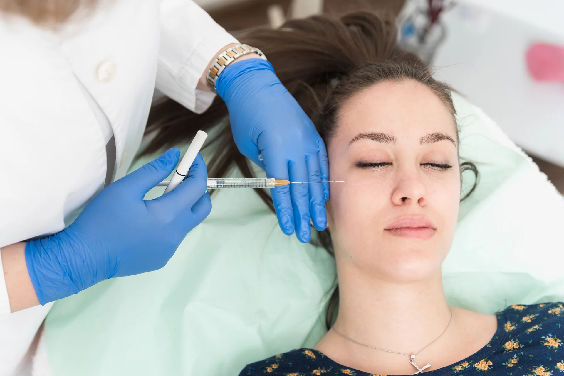 young woman had dermal filler treatment under her eyes inside a beauty clinic|woman receives dermal filler treatment under her eyes at Dr. Lanna Aesthetics' beauty clinic