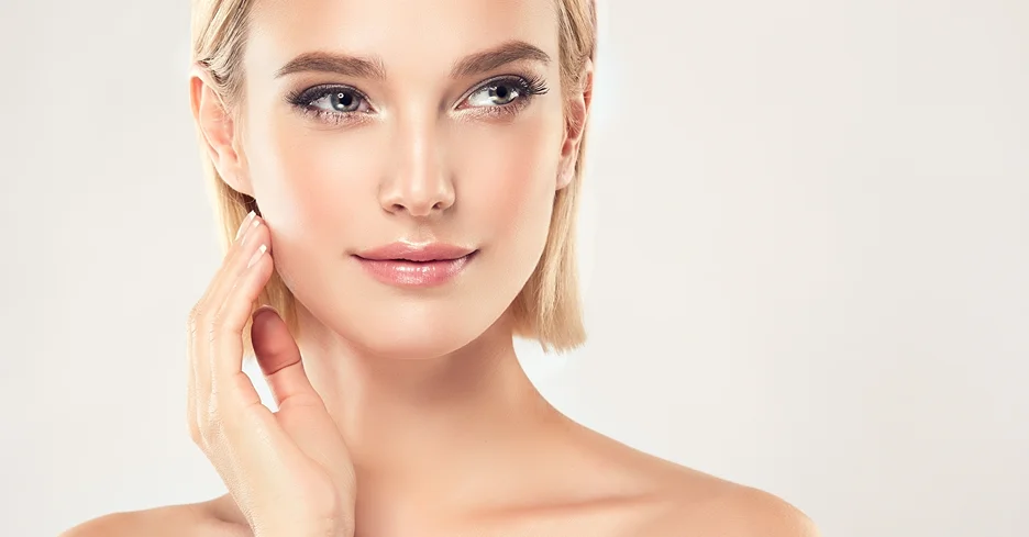 a portrait of a young woman touching her face