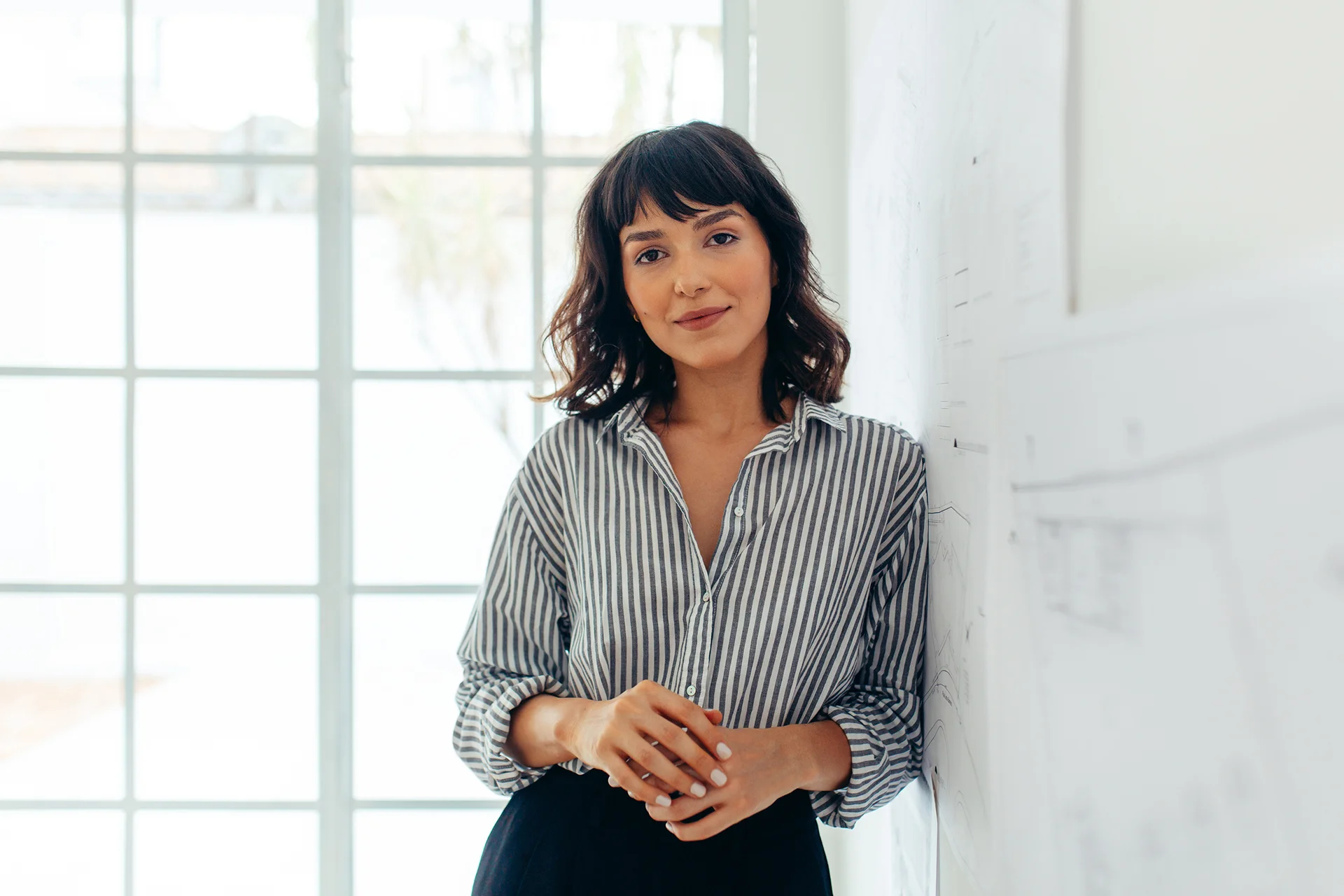 a portrait of a young woman inside her office||