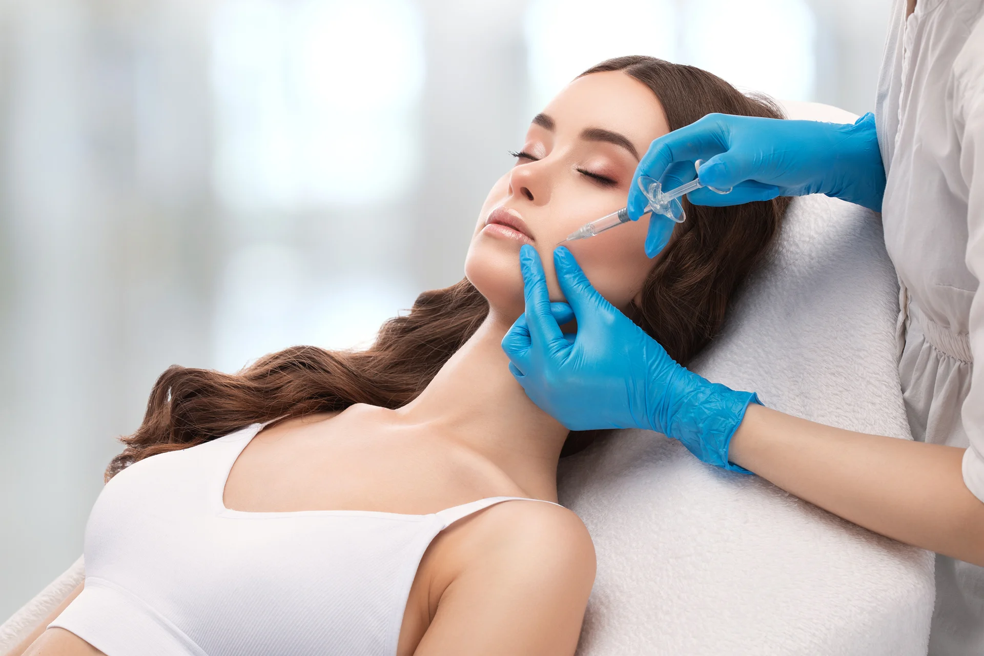 a woman getting cheek filler treatment||