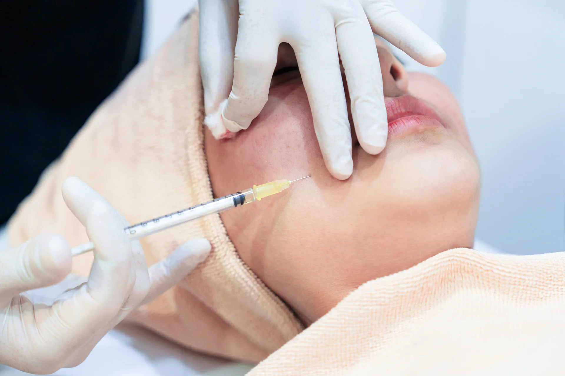 A Woman Getting Cheek Filler Treatment||