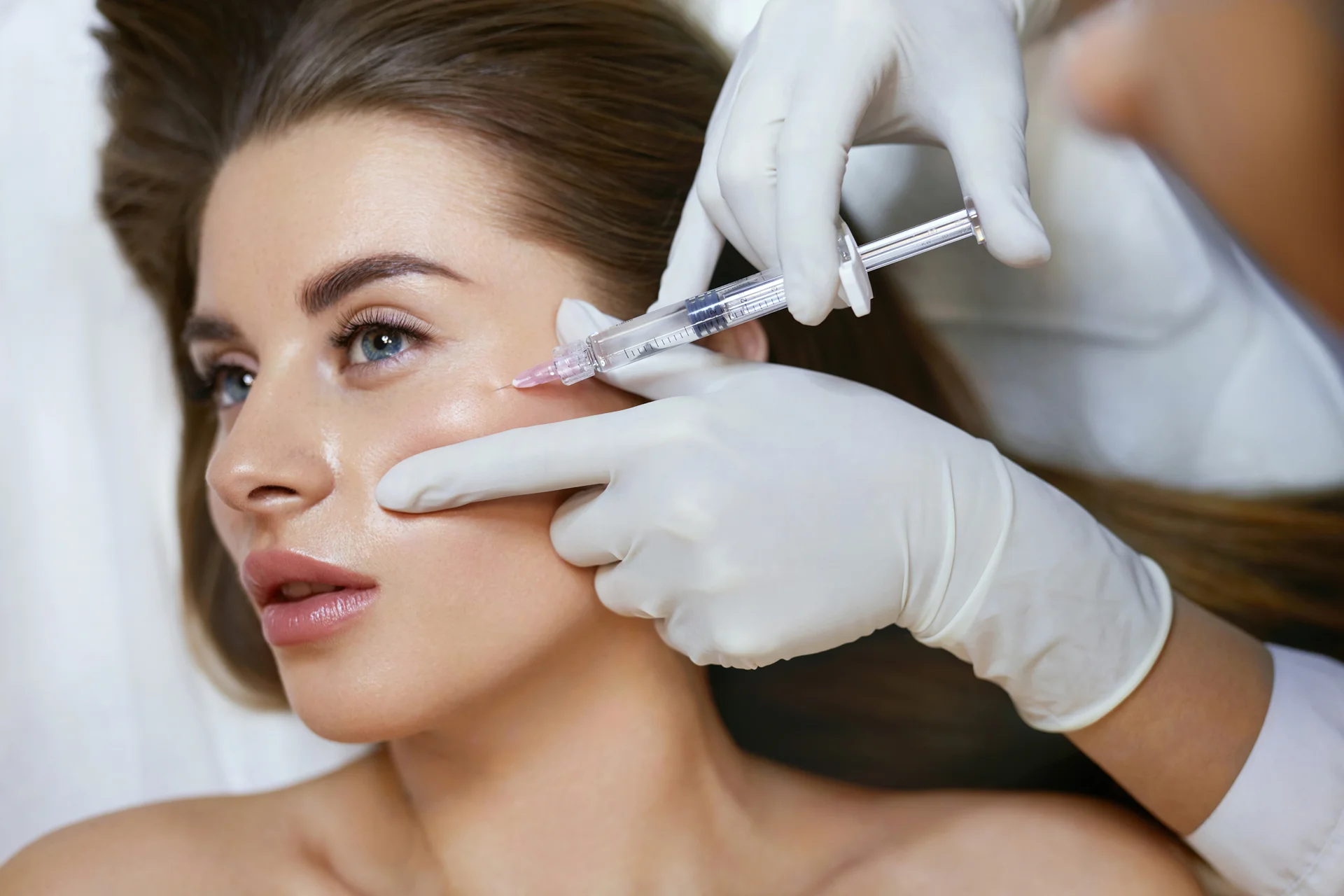 a woman getting cheek fillers||