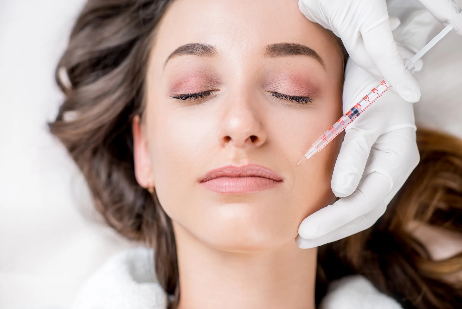 a woman getting cheek fillers||