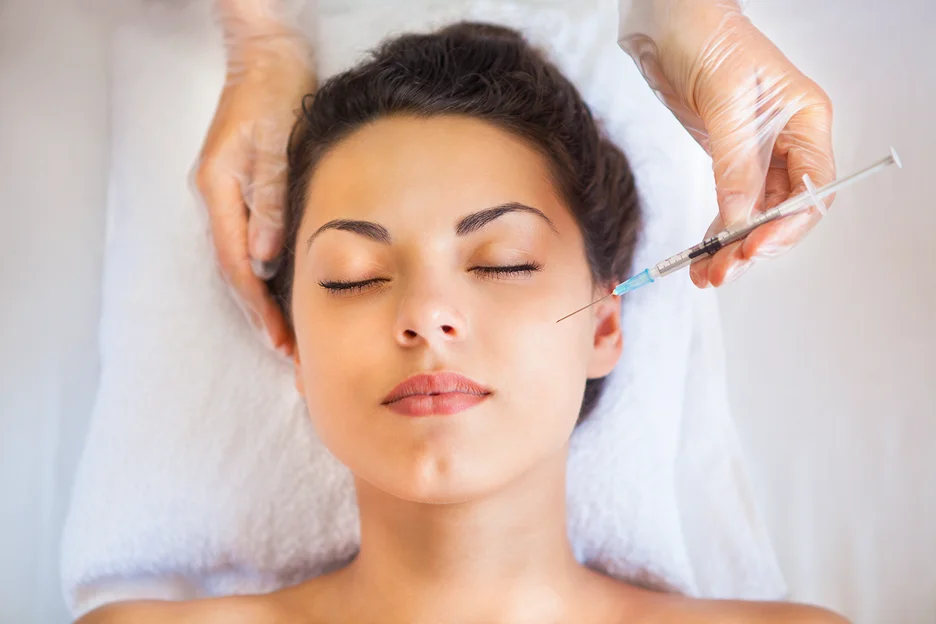a woman receiving cheek fillers