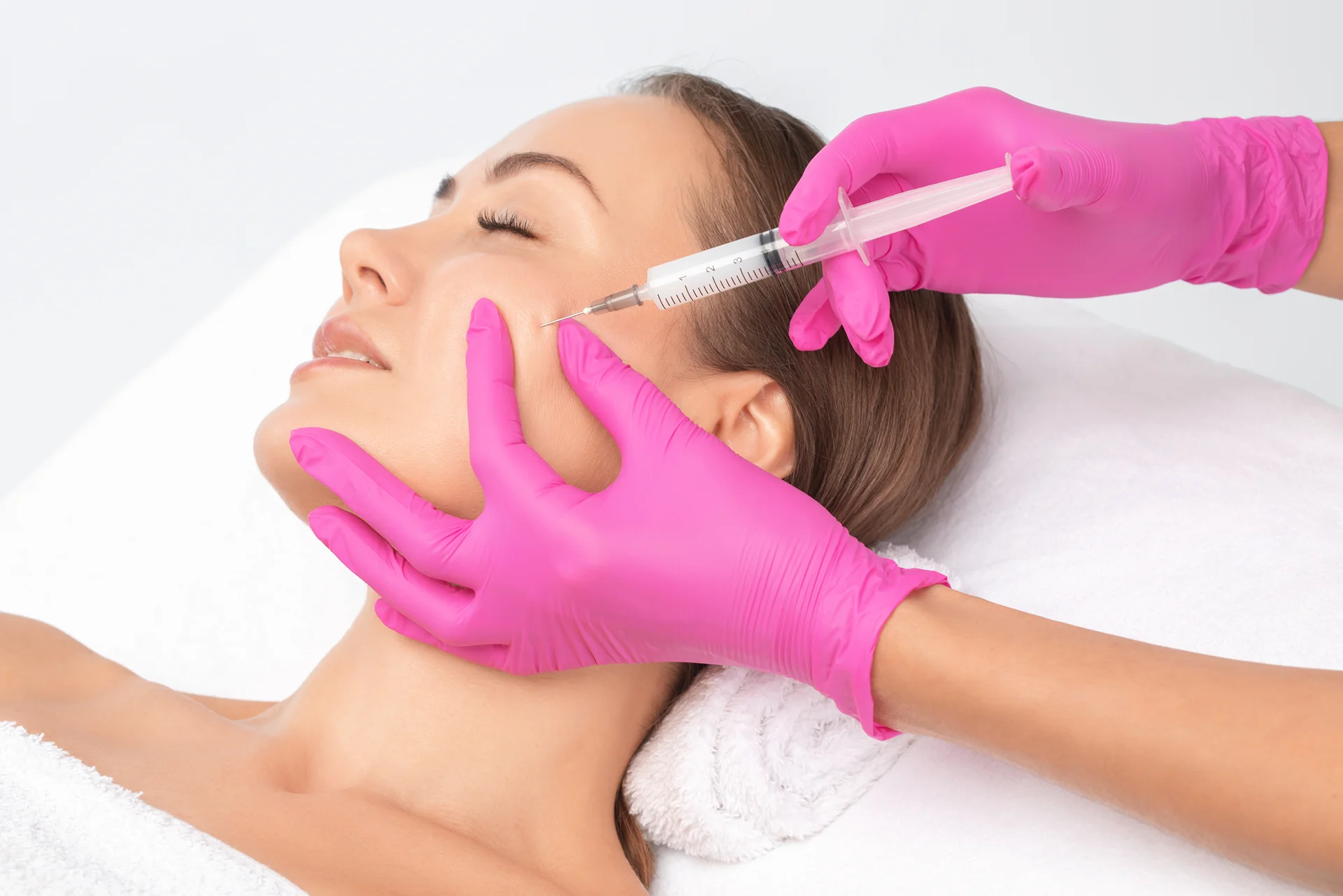 a woman getting cheek fillers||