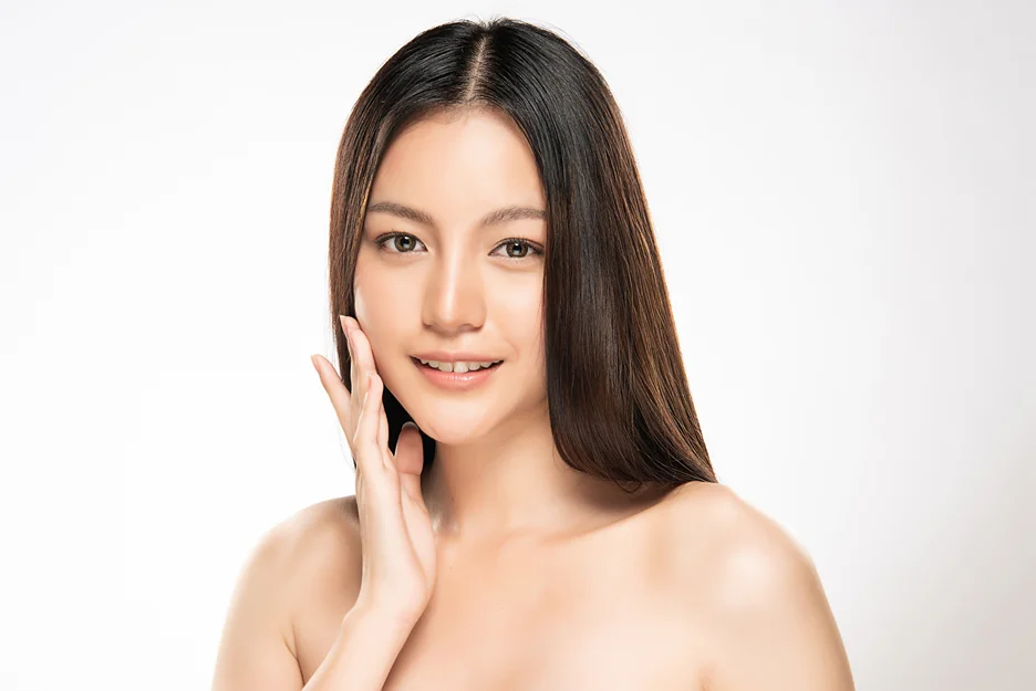 a beautiful woman holding her face