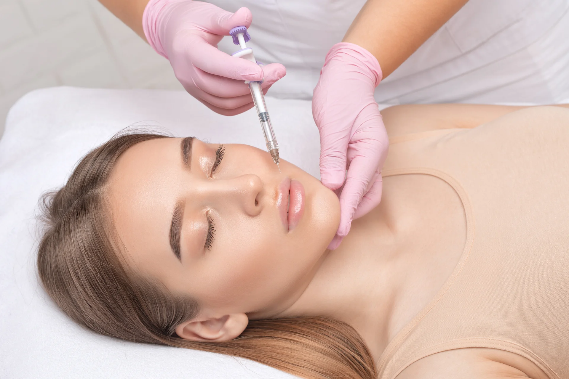 a woman had nasolabial dermal filler procedure|a beautiful woman holding her face|a woman had nasolabial dermal filler procedure at Dr. Lanna's clinic