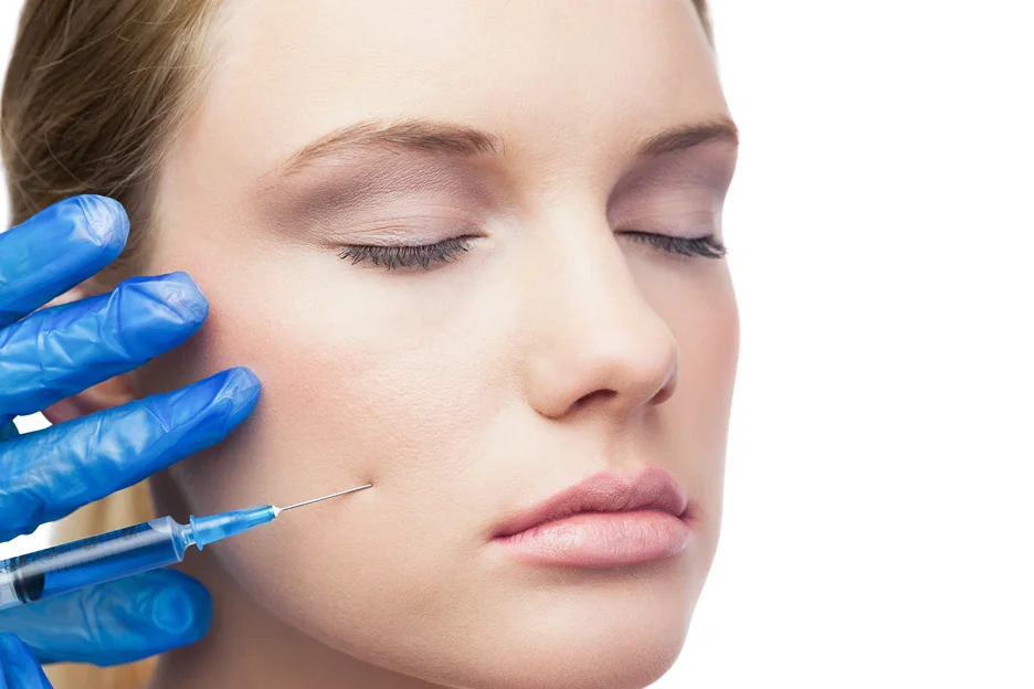 A woman getting cheek filler treatment