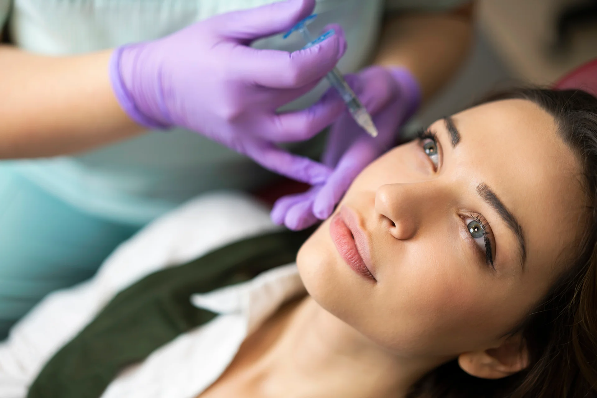 a woman getting cheek filler treatment||