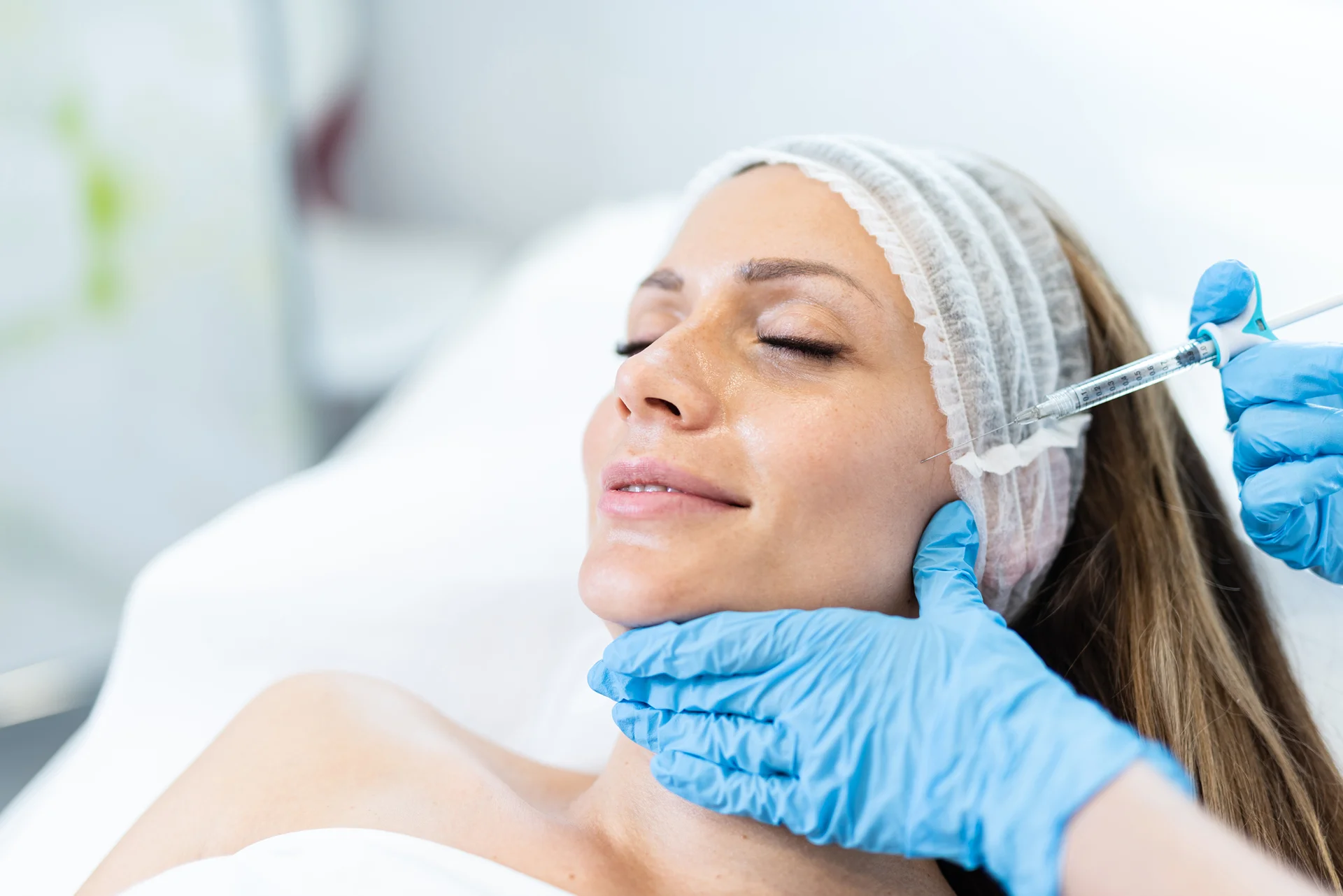 A woman getting cheek filler treatment|||