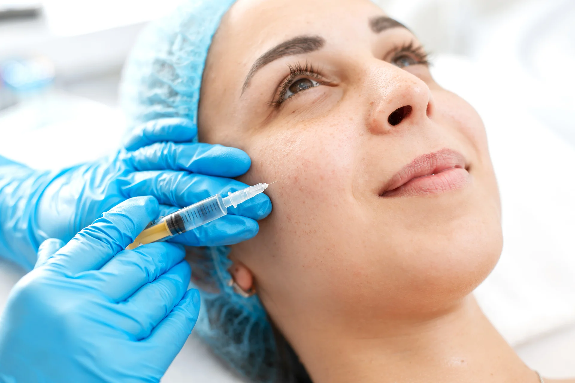 a woman getting cheek filler treatment||