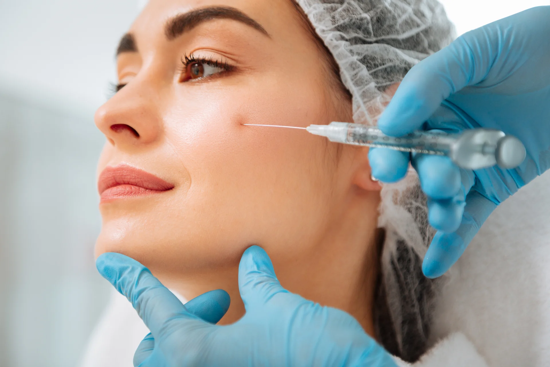 A woman getting cheek filler treatment|||