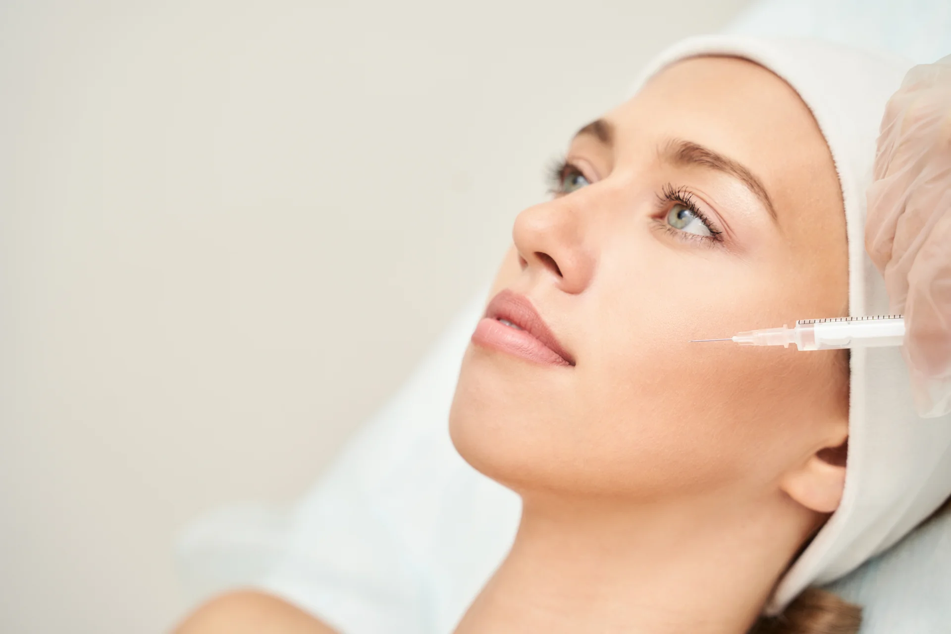 A woman getting cheek filler treatment||