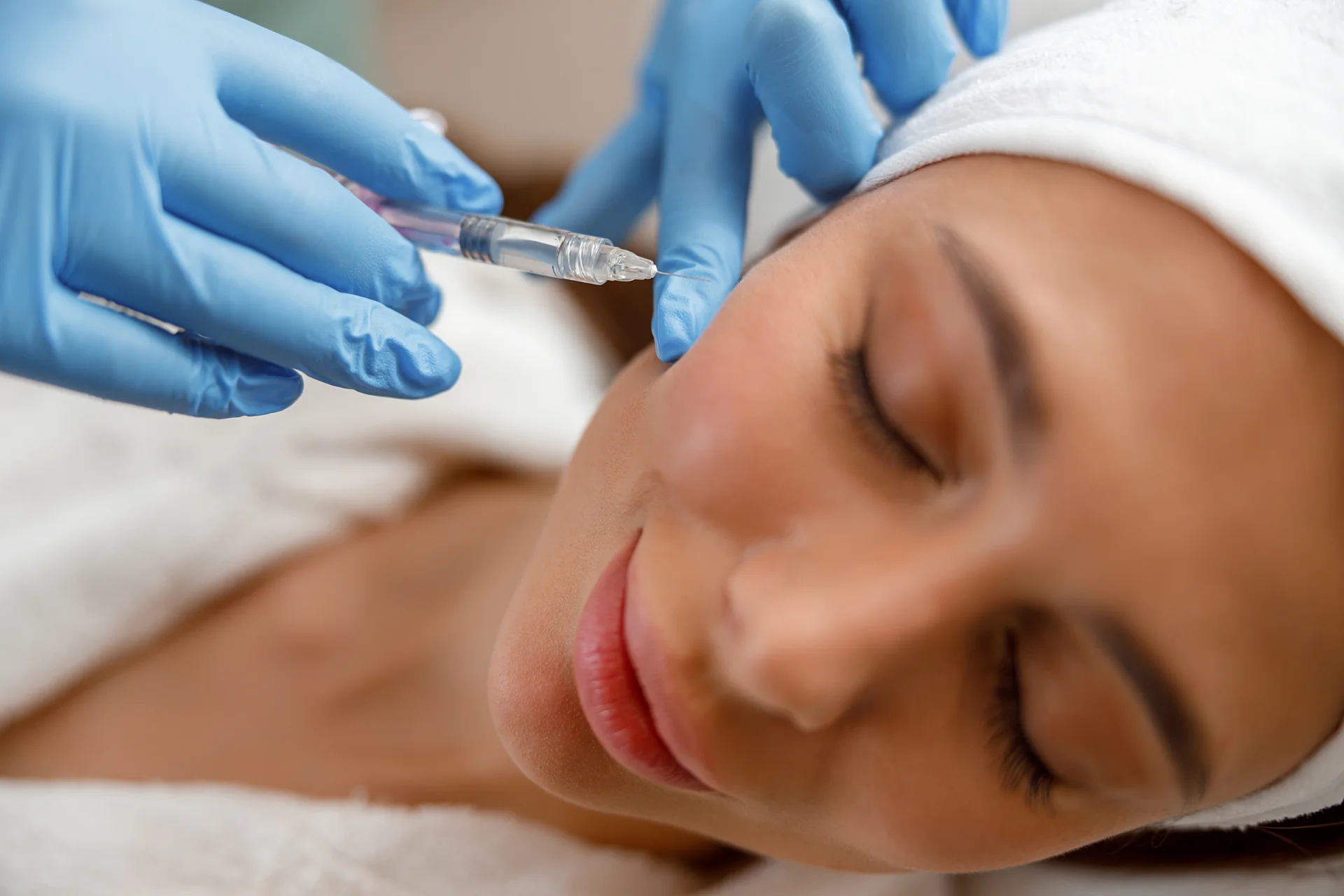 A woman getting cheek filler injection|||