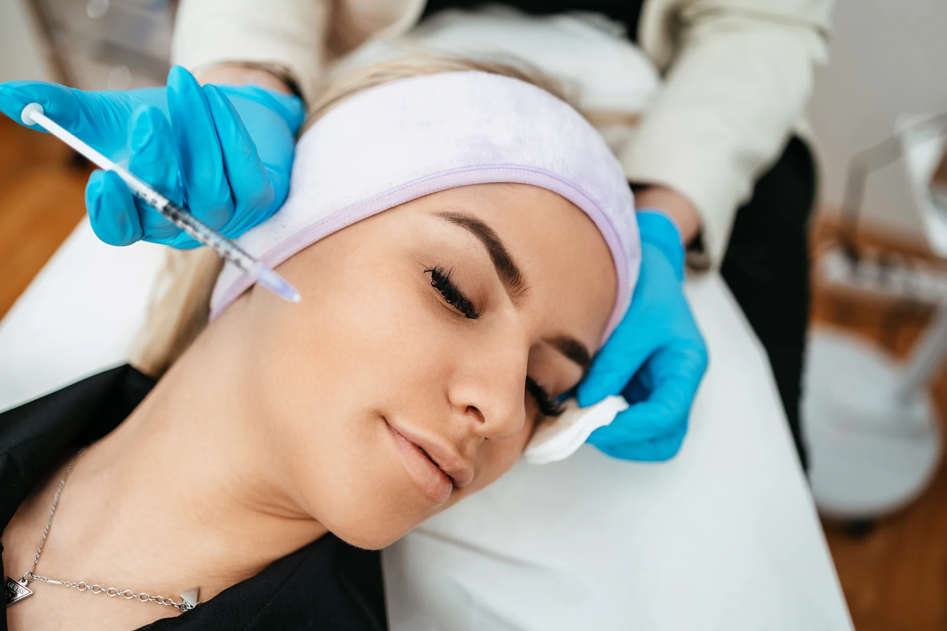 A woman getting cheek filler injection|||