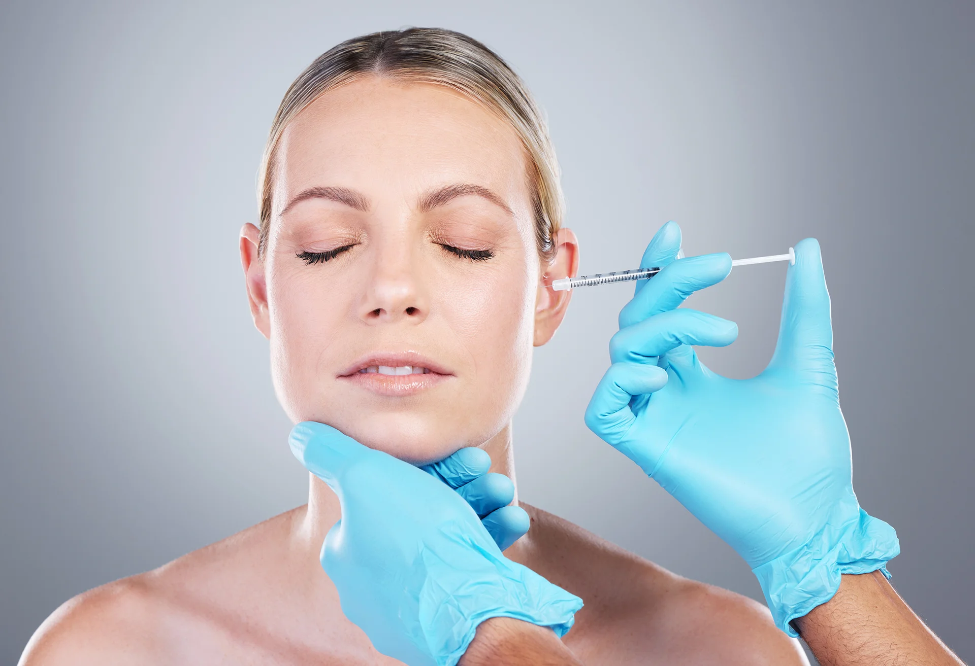 a woman getting cheek filler treatment||